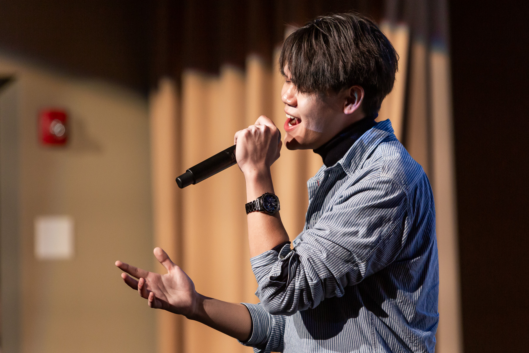 Xiangguang Liu, graduate student in the Driehaus College of Business, sings “Untainted” during the lunar new celebration. (DePaul University/Randall Spriggs)